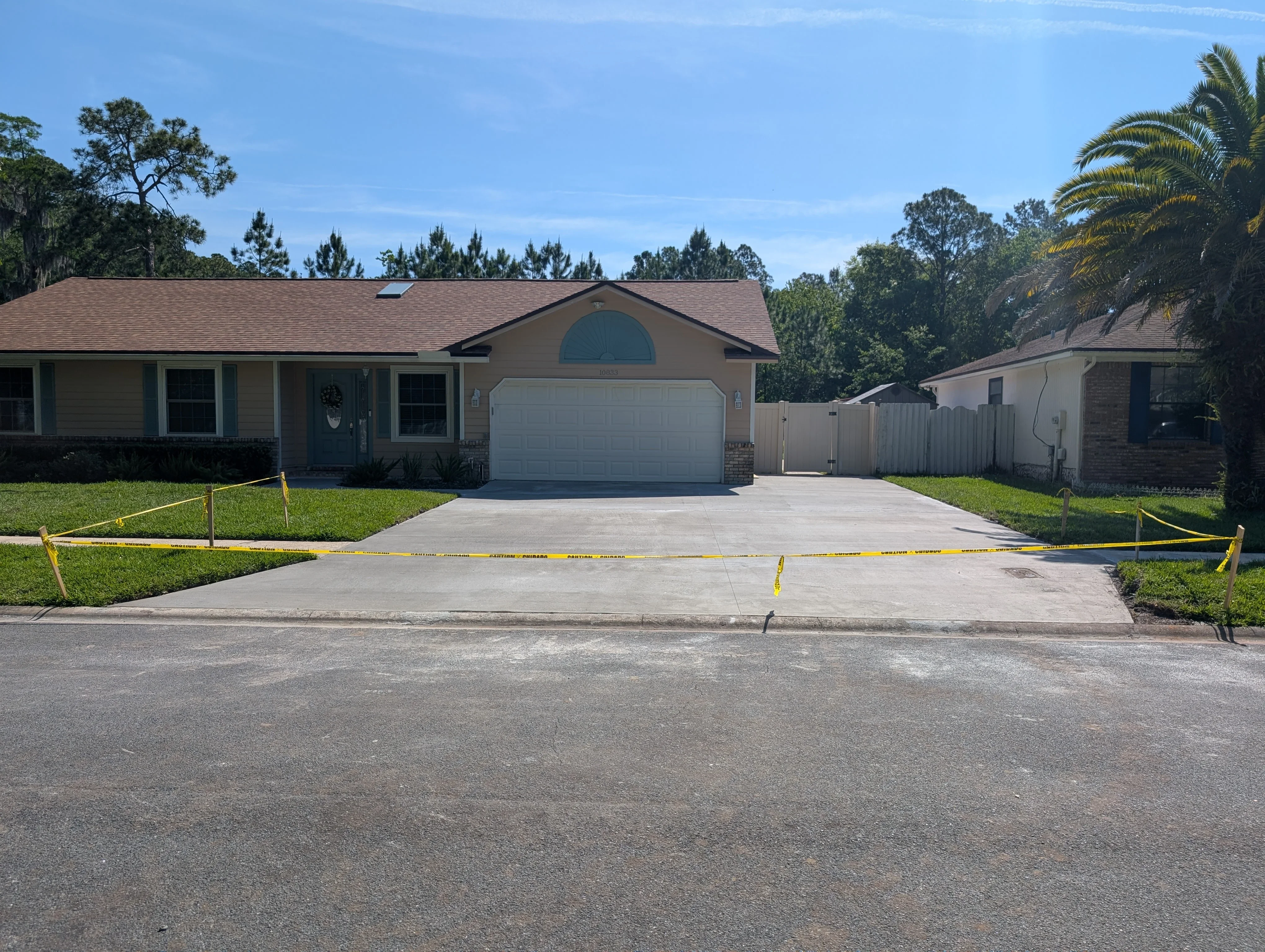 New concrete driveway with finished surface and clean edges at residential home