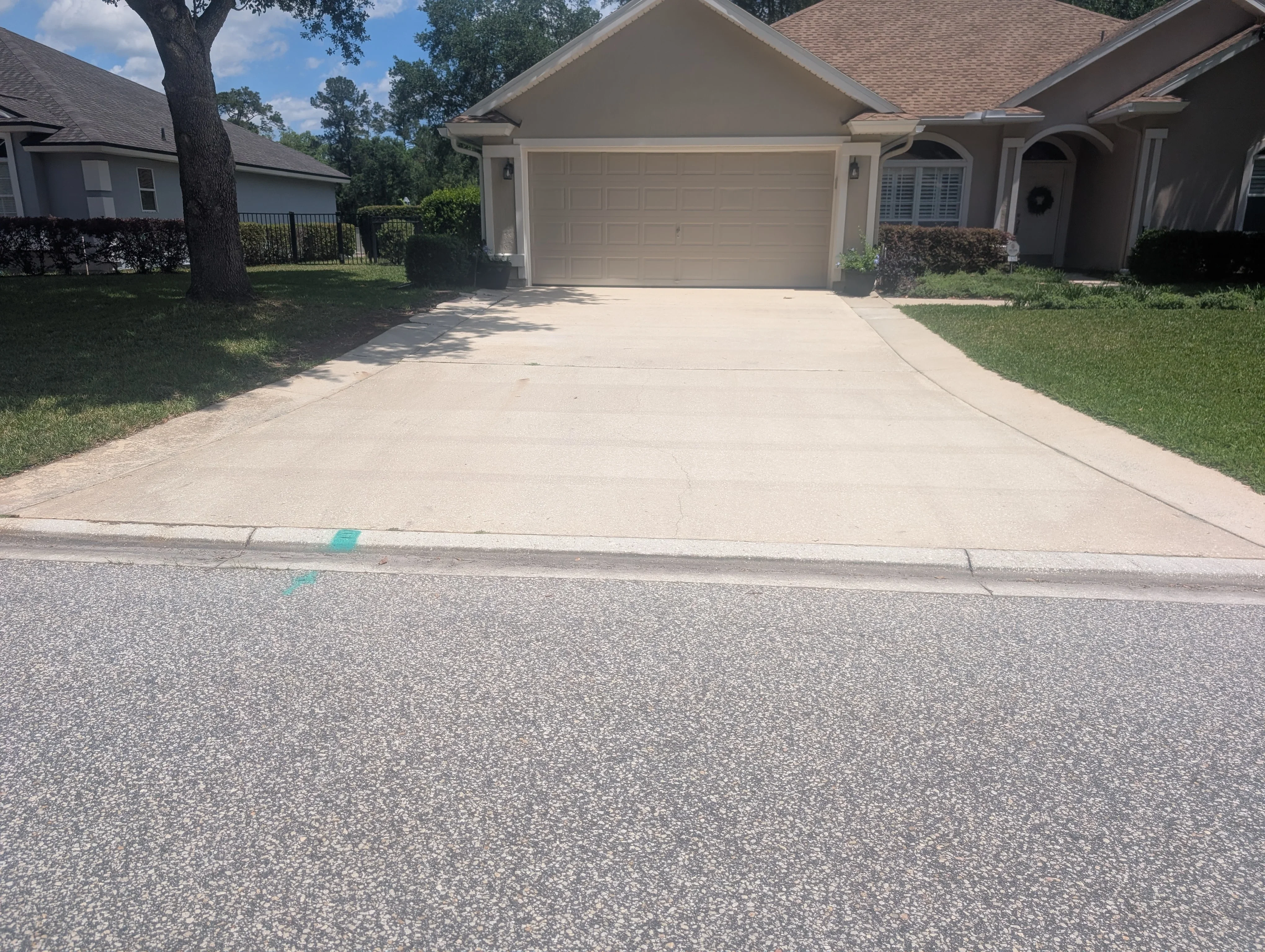 Finished concrete driveway with control joints and garage apron